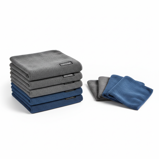 Stack of grey and blue microfibre car cleaning cloths on a white background